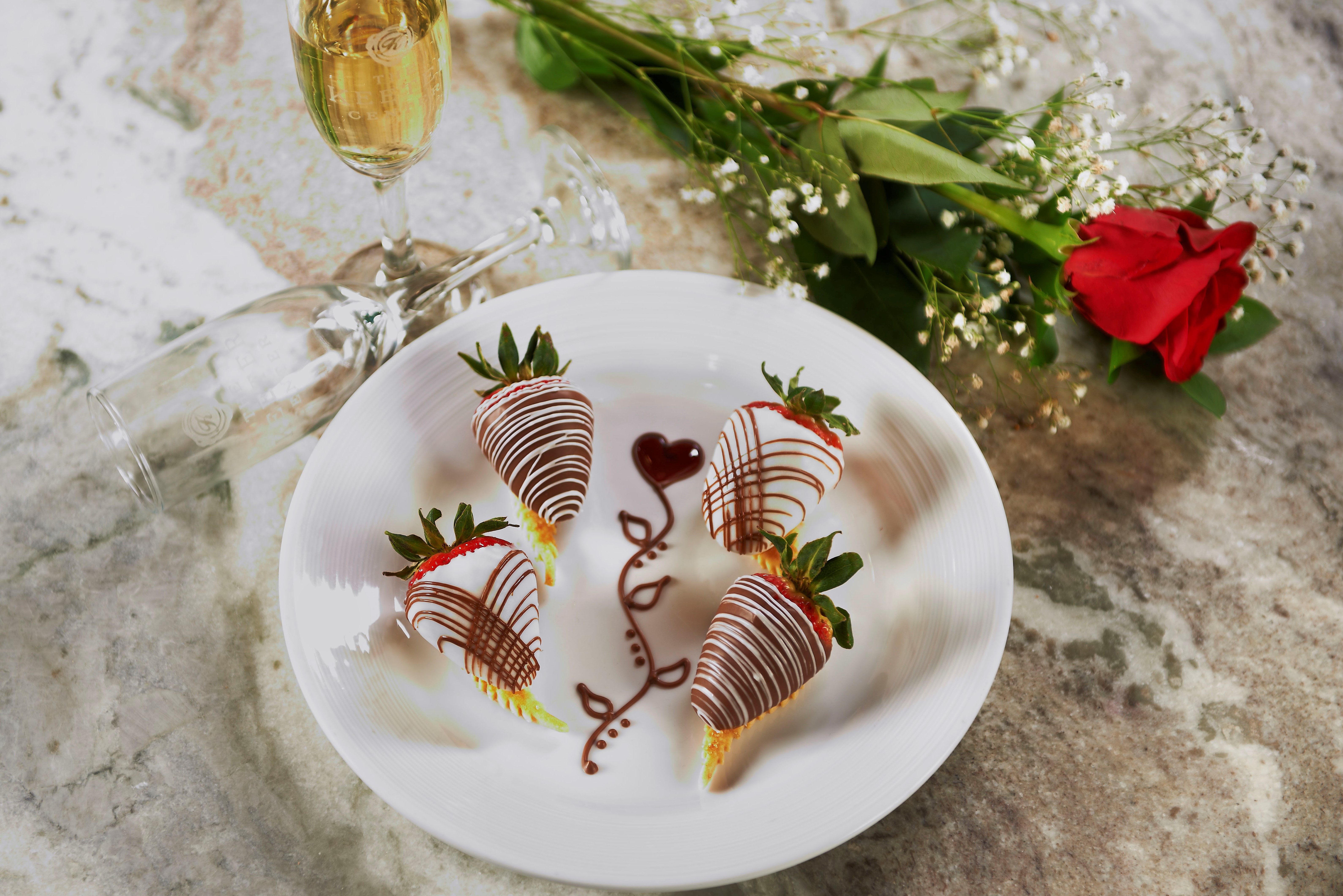 Chocolate strawberries laid out on a plate.
